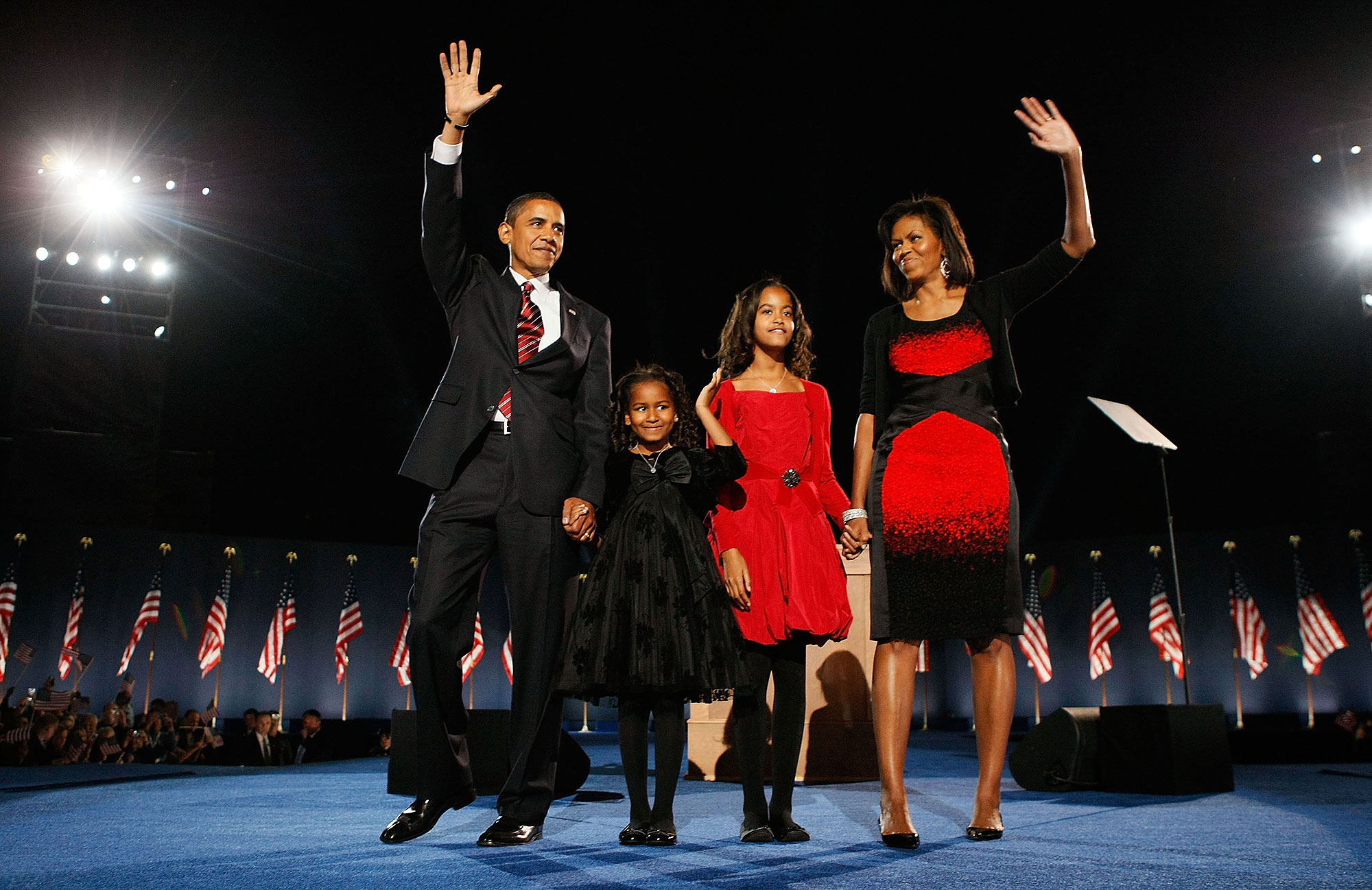 President-elect Barack Obama and family wave to a crowd.